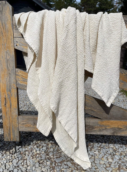 Ivory linen throw with embossed detail